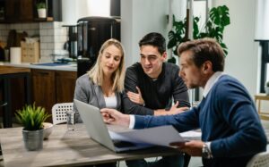 Estate agent showing clients potential properties and mortgage options